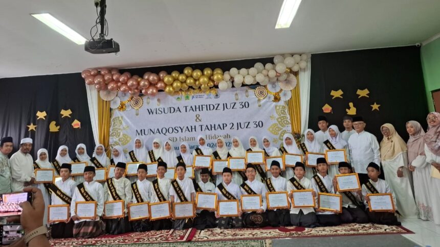 Acara Wisuda Tahfidz Juz 30 & Munaqosyah Tahap 2 di SD Islam Al Hidayah Pamulang berlangsung khidmat. Siswa-siswi menerima sertifikat dengan selempang kebanggaan, didampingi guru dan staf. Panggung berhias balon emas dan putih, mencerminkan semangat menghafal Al-Qur'an yang ditanamkan sekolah.